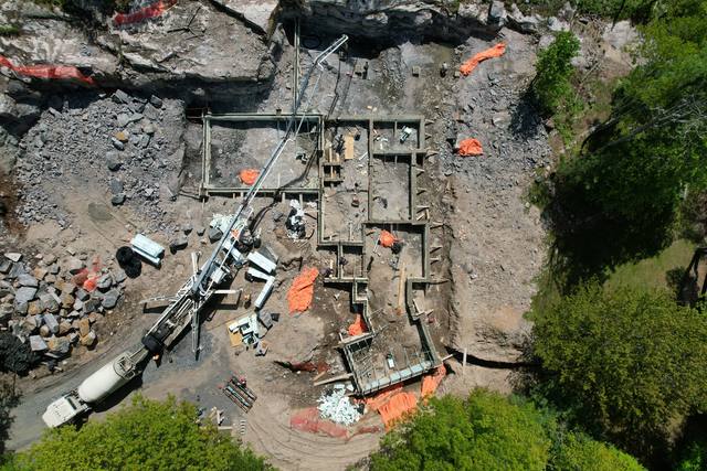 Straight down over a footing pour — the pump truck reaching the far corner