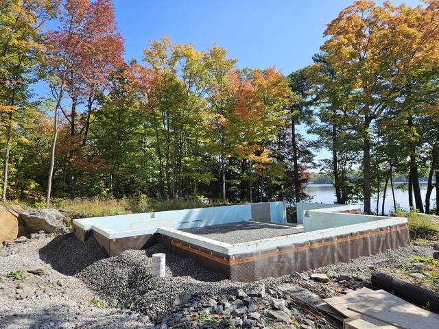 A finished foundation waiting on the framers, autumn on the lake