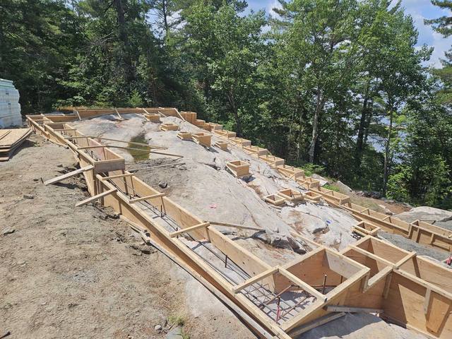 For Ballantyne Builds — footings formed over rock on a lakeside lot