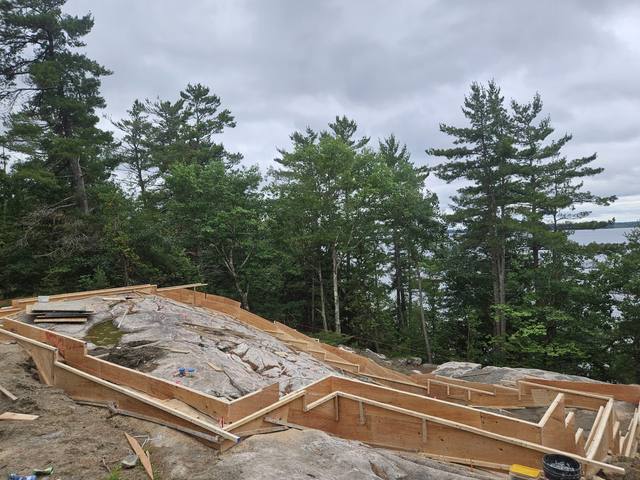Footing forms stepping across the rock face