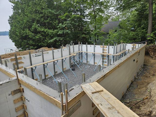 Formwork and reinforcement on a lakeside foundation before the pour