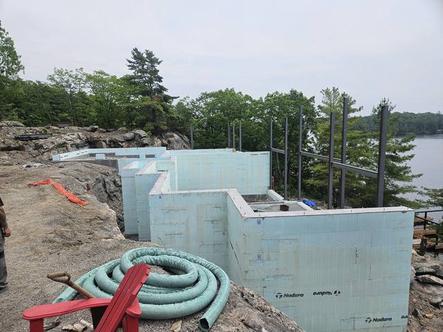 Services run into a lakefront foundation before the slab