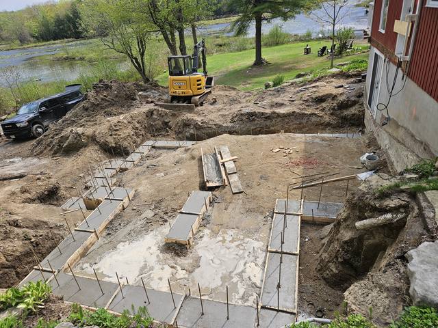 Legacy Project — excavation open on a lakeside lot