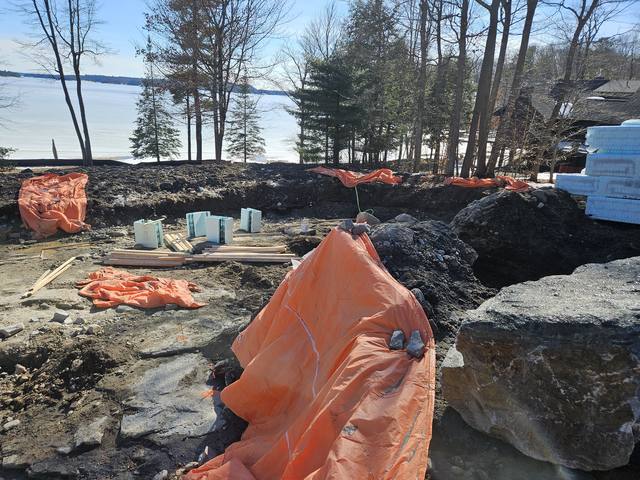Frost blankets over a rock excavation, mid-winter on the shoreline